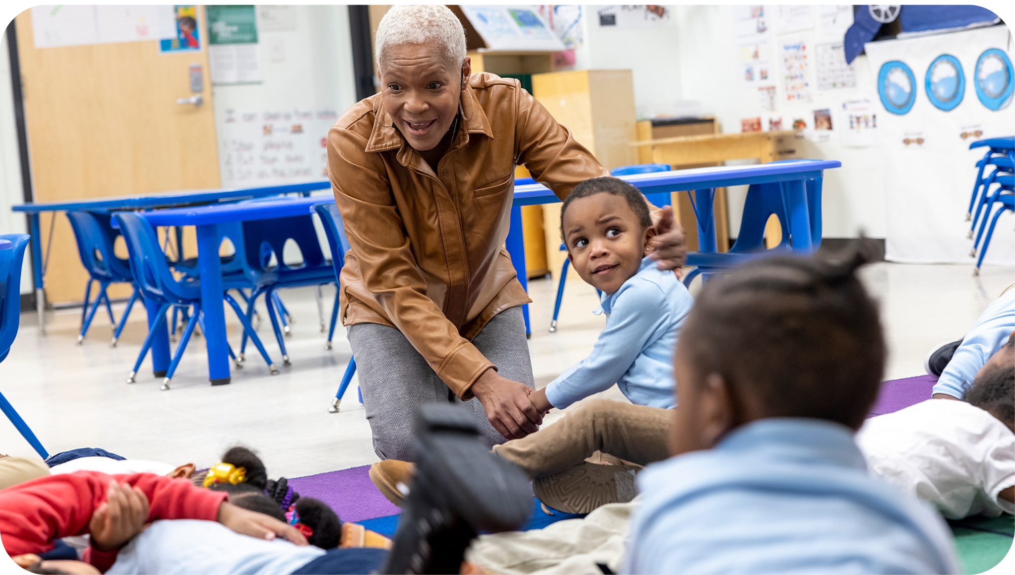 teacher participating in lecture with diverse students