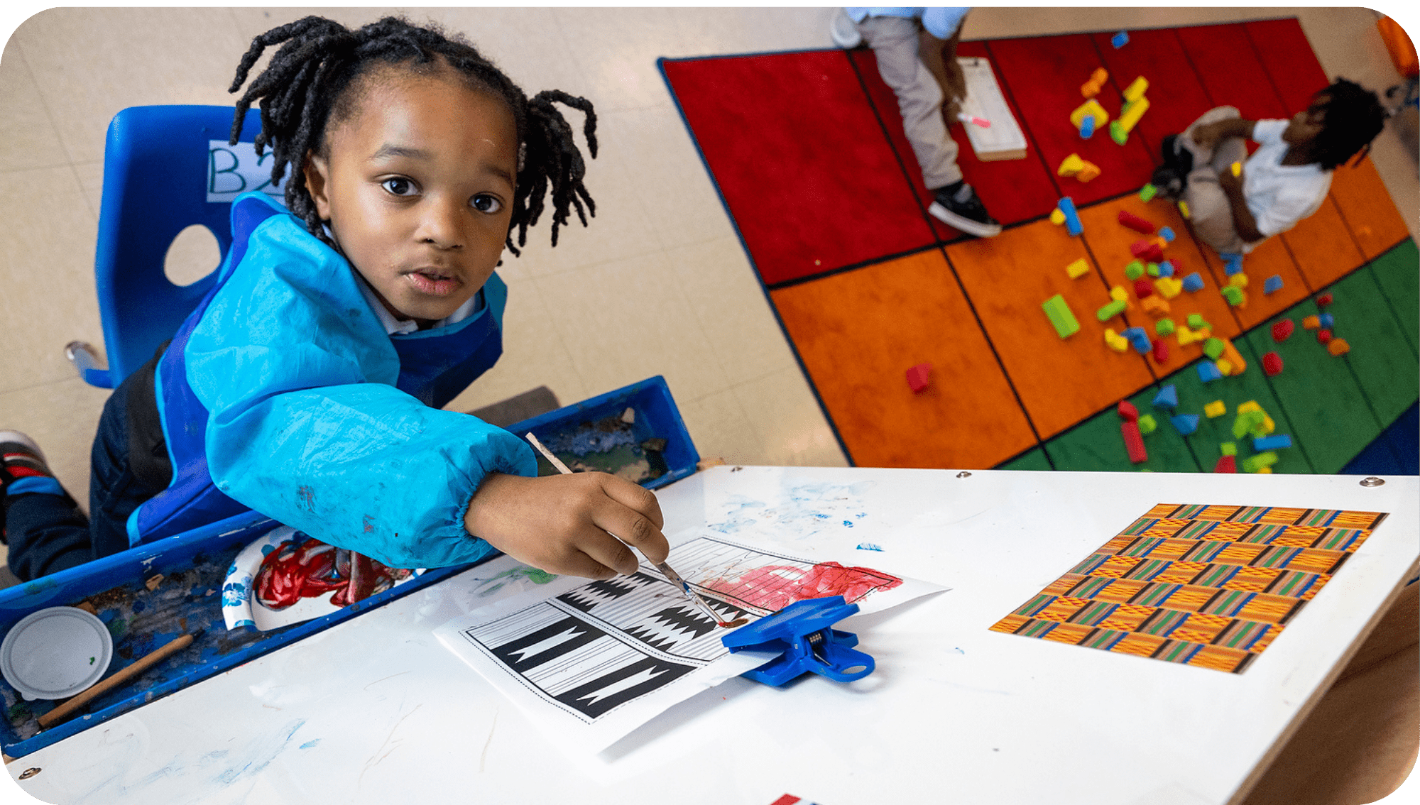 Child painting with colorful brushes and vibrant creativity